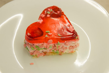 heart-shaped cake with berry filling on a white plate close-up