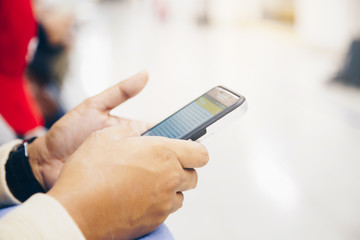 Business hand use smartphone in airport travel vacation close up on hand