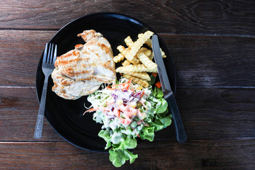 Chicken steak, french fries and salad