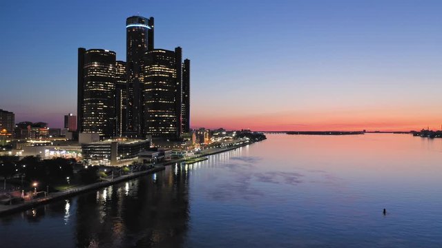 Aerial: Detroit city skyline and Detroit river at sunset. Detroit, Michigan, USA.