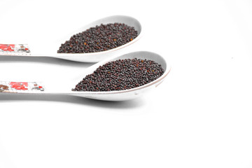 Black mustard seeds isolated on white background