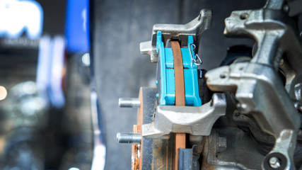 Close up car disk brake pad replacement service in car garage and copy space, use for disk brake service content