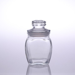 Empty glass jar isolated on white and grey clean and sharp