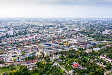 Obraz premium aerial panoramic view of city industrial area with railway hub. freight trains for cargo transportation. Minsk, Belarus