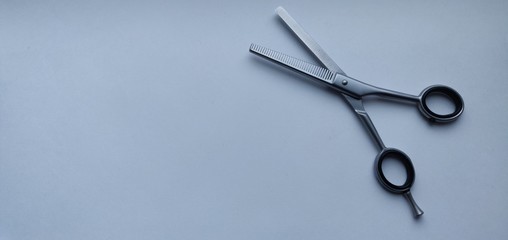  open hairdresser scissors on a white cold background