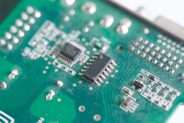 Close up of microchips on old green pcb board. Selective focus.