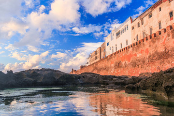 Ancient walls of the medina in Essaouira at sunset clouds