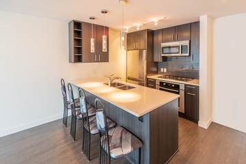 Modern, bright, clean, empty kitchen interior in a luxury apartment.