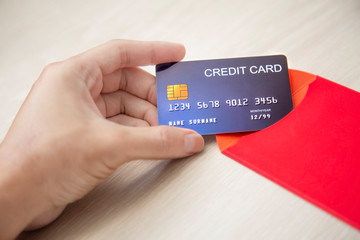 Hand Hold Credit Card and Red Envelope isolate White Background or space for text.