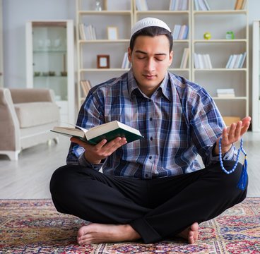 Young Muslim Man Praying At Home