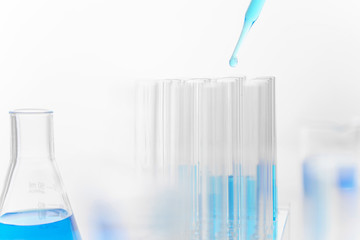 Scientist use pipette drops chemical liquid in test tube in laboratory