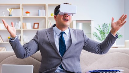 Businessman with virtual reality glasses in modern technology co