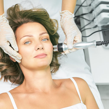 Dermatology skin care facial therapy. Medical spa anto wrinkles procedure. Woman face rejuvenation. Pretty girl. Rf cosmetician equipment