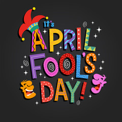 April Fool's Day design with hand drawn decorative lettering, laughing cartoon faces and jester hat. For greeting cards, banners, flyers, etc.