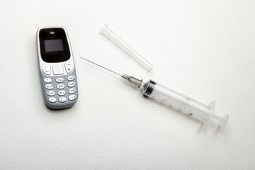mobile phone syringe leather background 