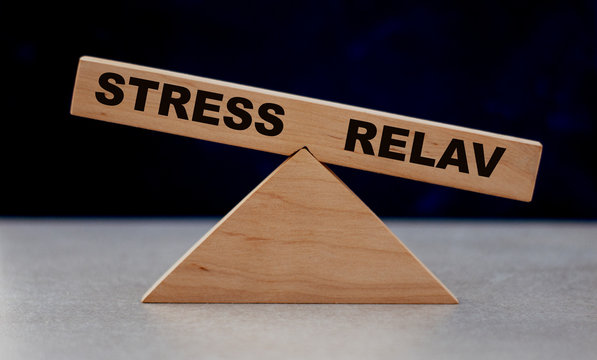 concept of the balance of words stress and relaxation on wooden scales