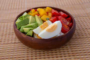 Salad with mango, avocado, egg, romeo tomatoes