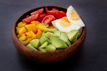 Salad with mango, avocado, egg, romeo tomatoes