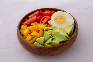Salad with mango, avocado, egg, romeo tomatoes