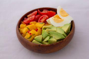 Salad with mango, avocado, egg, romeo tomatoes