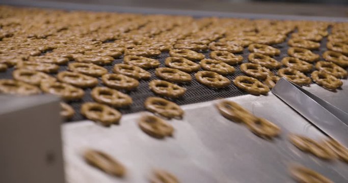 Snacks production Closeup conveyor, baked pretzel snacks