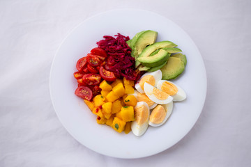 Salad with mango, avocado, egg, romeo tomatoes