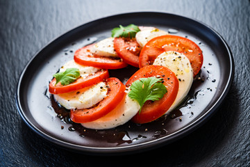 Caprese salad on black stone