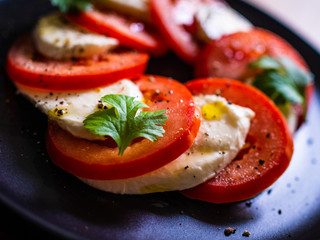 Caprese salad on black stone