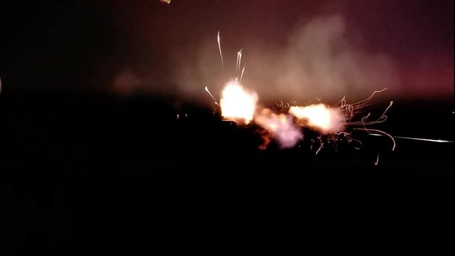 Shots of an Automatic Rifle in the dark. Staged Shootout. Imitation shooting.