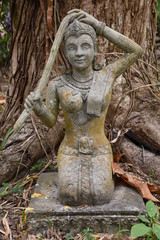 Fototapeta na wymiar Statue of Lao Woman Kneeling, Washing Hair, Cool Hues, Portrait