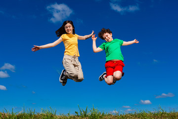 Girl and boy running, jumping outdoor