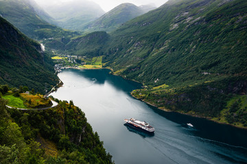 Fototapeta na wymiar Fjord Geirangerfjord with cruise ship, view from Ornesvingen viewing point, Norway. Travel destination