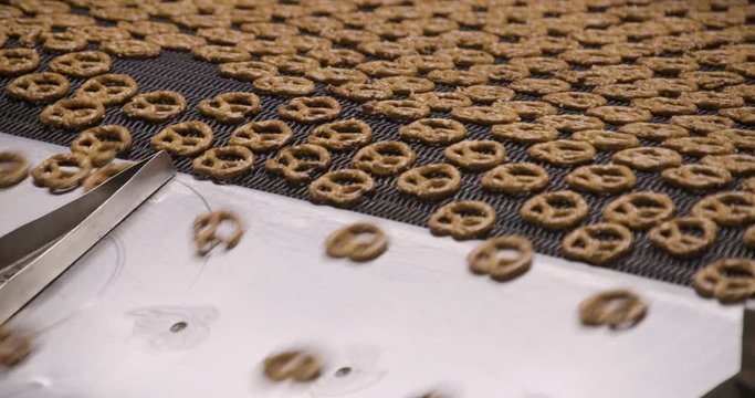 Snacks production Closeup conveyor, baked pretzel snacks