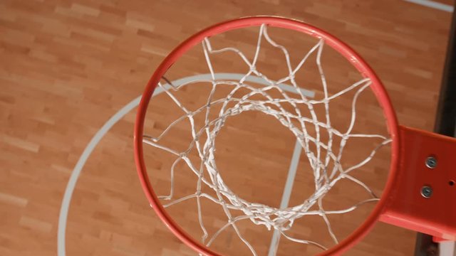 Close up shot of a basketball hoop made with a professional video crane. Basketball commercial. 4K Slow motion shot
