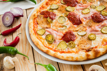 tasty pizza on the wooden background