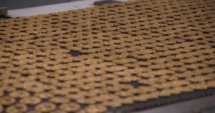 Snacks production Closeup conveyor, baked pretzel snacks