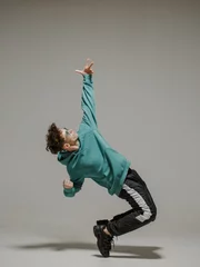 Fotobehang Boy dancing contemporary dance in studio. Acrobatic dancer. © Georgii