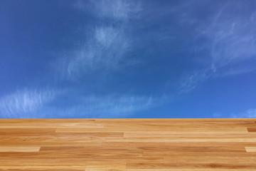 light brown wooden planks as a wood table or parquet floor in perspective, isolated on blue sky or white clouds.