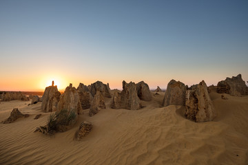 Sun setting behind the limestone stacks in the Pinnacles desert in the Nambung national park located north of Perth in Western Australia