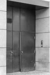A large metal door is slightly open