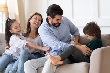 Happy family with kids have fun relax on sofa together