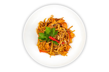 Pan asian food. Wok noodles on a white plate, top view. White isolated background