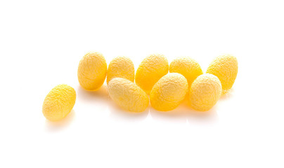 yellow thai silkworm cocoons pile an isolated on white background