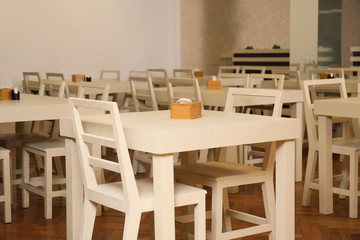 Stylish interior of school canteen with new furniture