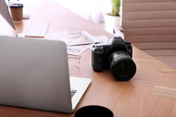Photographer's workplace with professional camera in office