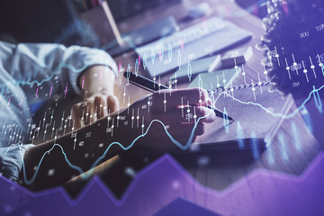 Financial forex charts displayed on woman's hand taking notes background. Concept of research. Double exposure