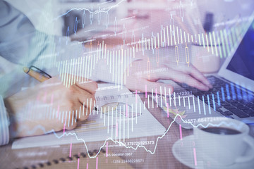 Multi exposure of stock market graph with man working on laptop on background. Concept of financial analysis.