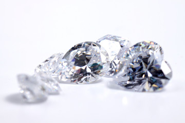 Macro shoots of a group of diamonds that has different shapes, heart, round, pear, asscher, oval, princess, isolated background