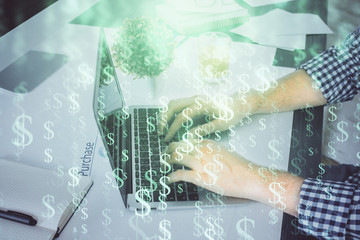 Double exposure of graph with man typing on computer in office on background. Concept of hard work.