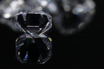 Macro shoots of a group of diamonds that has different shapes, heart, round, pear, asscher, oval, princess, isolated background